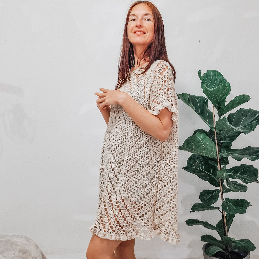 Colorful granny square summer dress by Loops Only featuring vibrant crochet patterns and a sleeveless, breezy design.