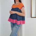 Color block top by Loops Only featuring vibrant, contrasting sections and a stylish, casual design.