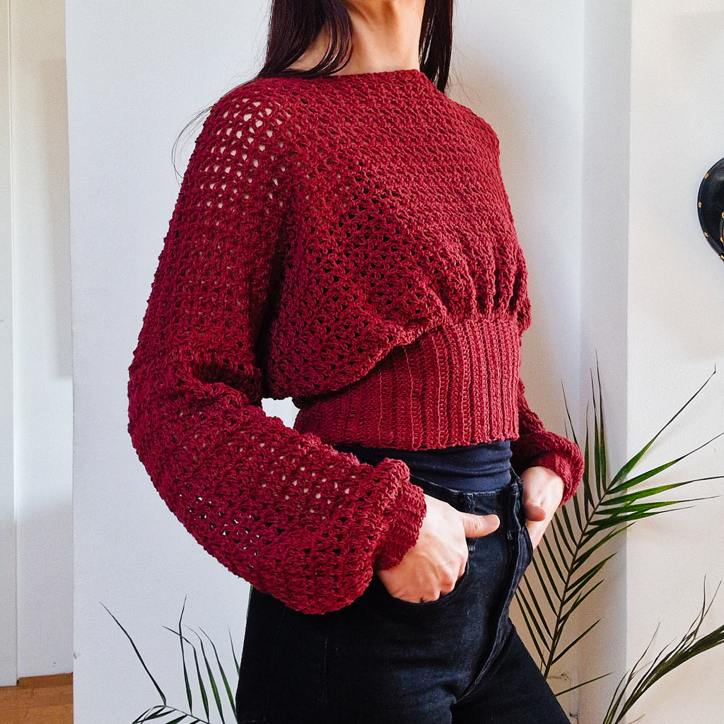 Crochet cropped bishop sleeve sweater by Loops Only, featuring textured knit and voluminous bishop sleeves.