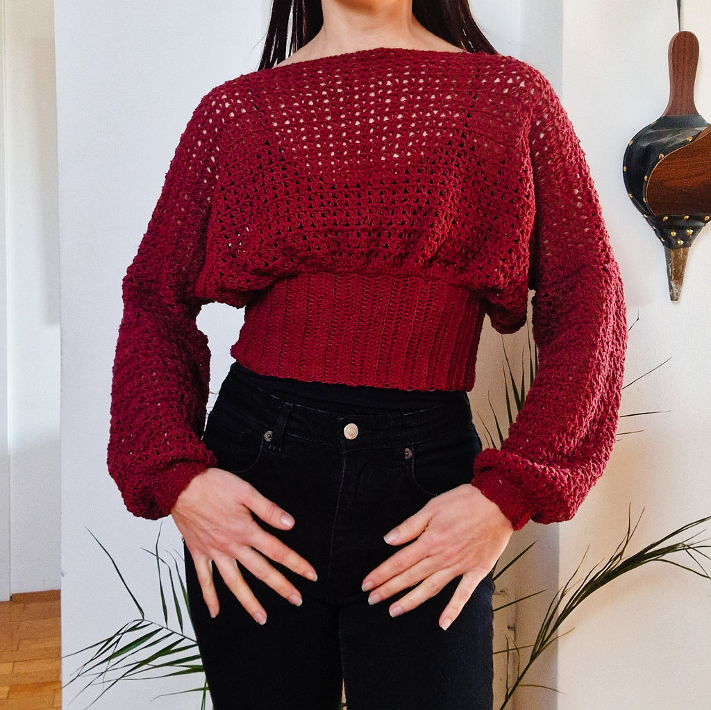 Crochet cropped bishop sleeve sweater by Loops Only, featuring textured crochet fabric and voluminous bishop sleeves.