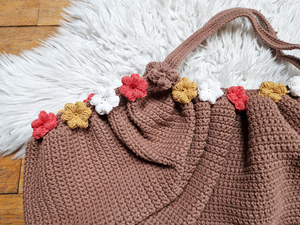 Loops Only garden tote bag with multiple compartments and sturdy handles, perfect for carrying gardening tools and supplies.