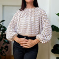 Loops Only granny tie sweater featuring a cozy knit design, with a distinctive tie detail at the neckline.