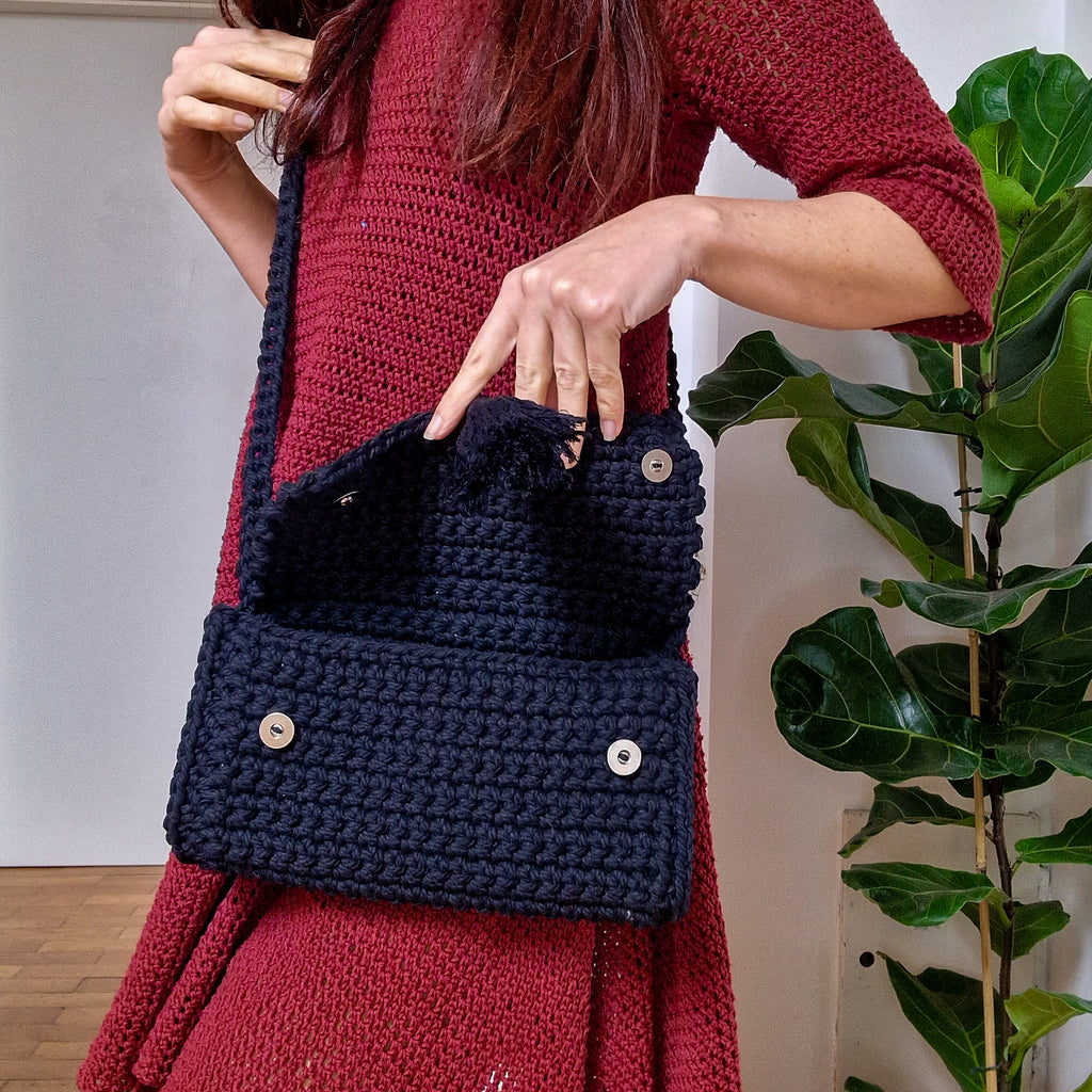 Loops Only Maven crossbody purse in black leather with adjustable strap and gold-tone hardware.