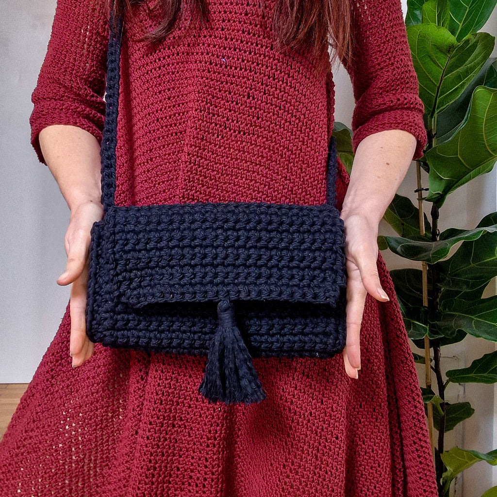 Loops Only Maven crossbody purse featuring a sleek design, adjustable strap, and compact storage in a stylish bag.